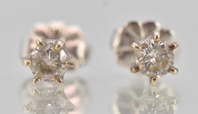 Lot 1451 - A pair of 14ct white gold diamond ear studs,...