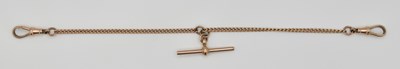 Lot 1147 - A 9ct rose gold Albert style watch guard, with...