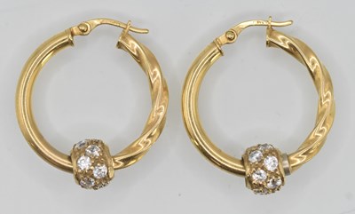 Lot 1411 - A pair of 9ct yellow gold hoop earrings with a...