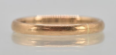Lot 1297 - A 9ct rose gold thin band ring, size S, approx...