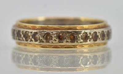 Lot 1251 - A 9ct yellow gold eternity ring, with central...