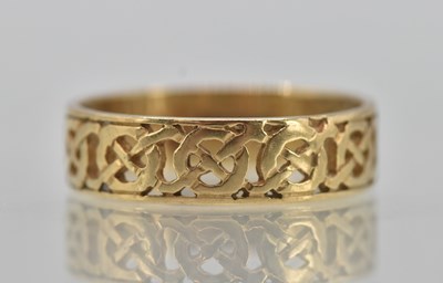 Lot 1263 - A 9ct yellow gold band ring, with open Celtic...