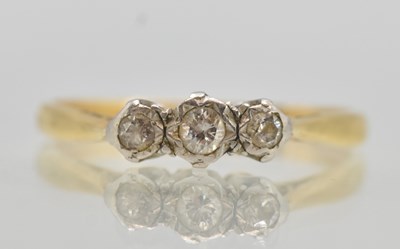 Lot 1325 - A gold ring set with three small diamonds,...