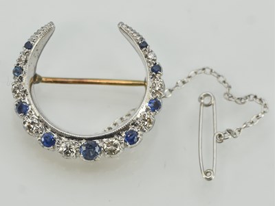 Lot 1496 - A 9ct gold diamond and sapphire set crescent...