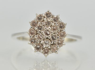 Lot 1196 - An 18ct white gold diamond cluster ring, the...