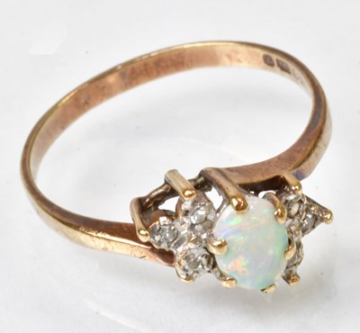 Lot 744 - A 9ct yellow gold ring set with an oval opal...
