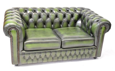 Lot 28 - A green leather two-seater Chesterfield setee,...
