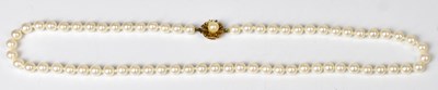 Lot 823 - A single-strand pearl necklace set with a gold-...