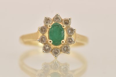 Lot 1408 - A 14ct yellow gold ring, with claw set green...