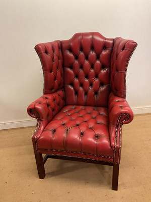 Lot 631 - A red leather button wing back chair, 118 x 90...