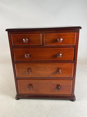 Lot 654 - A small mahogany chest of two short over three...