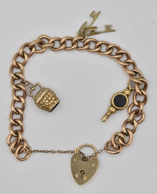Lot 1451 - A 9ct yellow gold charm bracelet, with padlock...