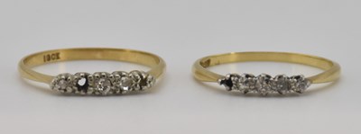 Lot 1229 - An 18ct yellow gold diamond five stone ring...
