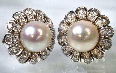 Lot 830 - A pair of 18ct white gold flower head stud...