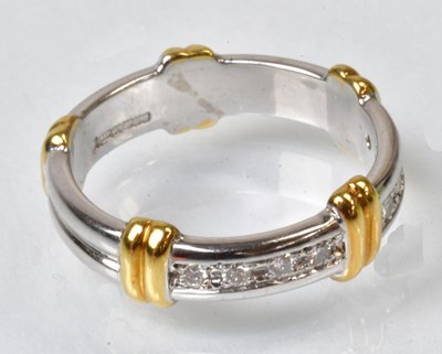 Lot 842 - An 18ct white gold band ring with yellow gold...
