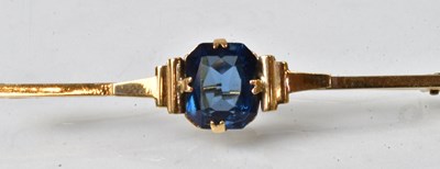 Lot 809 - A 9ct yellow gold bar brooch set with a blue...