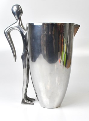 Lot 479 - An unusual polished alloy jug, the handle...