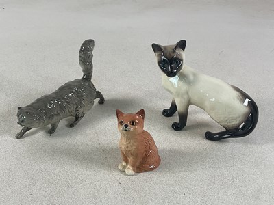 Lot 283 - ROYAL DOULTON; three ceramic cat models...