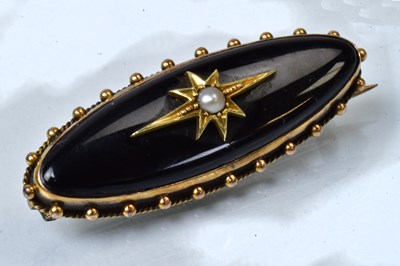 Lot 808 - A 15ct yellow gold elongated oval brooch, set...
