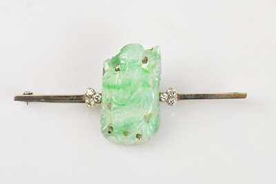 Lot 154 - A white metal diamond and jade bar brooch, set...