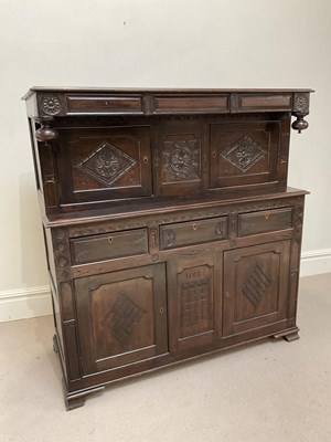 Lot 1034 - A 17th century style carved oak court cupboard,...