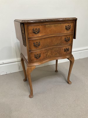Lot 1137 - A 1950s walnut serpentine fronted chest of...