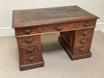 Lot 1086 - A late 19th century carved oak twin pedestal...