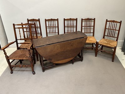 Lot 1038 - An 18th century style oak drop-leaf gateleg...