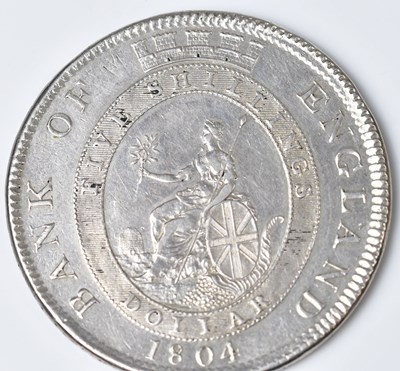 Lot 607 - A George III Bank of England silver dollar,...