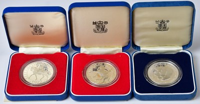 Lot 659 - Three silver proof crowns in blue leatherette...
