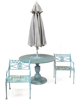 Lot 77 - A cast metal circular garden dining table with...