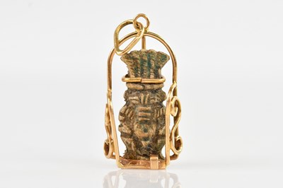 Lot 1355 - An Egyptian 18ct gold mounted Bes pendant, 3.5cm.