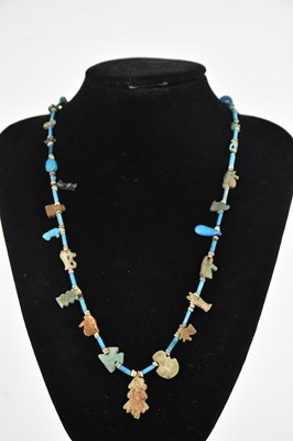 Lot 1356 - An Egyptian bead necklace decorated with...