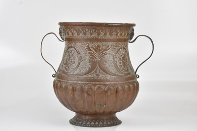 Lot 1300 - A twin handled embossed copper jardiniere,...