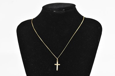 Lot 399 - A 9ct yellow gold cross pendant, suspended on...