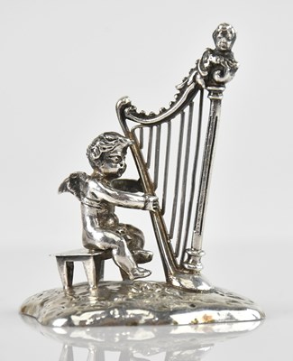 Lot 199 - An 800 grade silver cherub playing a harp,...