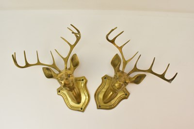 Lot 480 - A pair of brass stag's heads mounted on brass...
