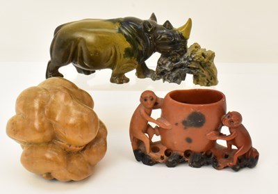 Lot 291 - A carved soapstone rhinoceros eating bushes,...