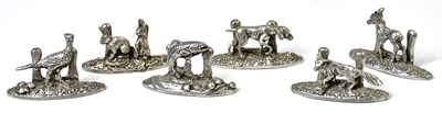 Lot 318 - A set of six polished pewter place card...