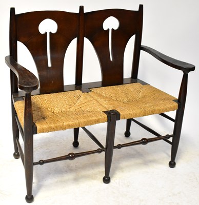 Lot 27 - An Arts and Crafts two-seat settle, the shaped...
