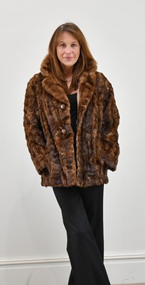 Lot 1375 - A short light brown mink paw jacket with mink...