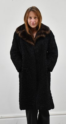 Lot 1380 - A black knee-length Persian lamb coat with...