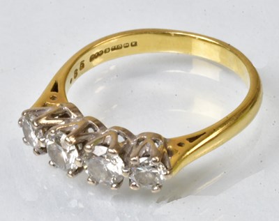 Lot 763 - An 18ct yellow gold ring set with four...