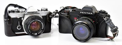 Lot 383 - An Olympus OM1 camera in branded leather carry...
