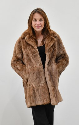 Lot 1367 - A short light brown musquash fur jacket.