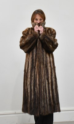 Lot 1372 - A full-length musquash fur coat, fully lined,...