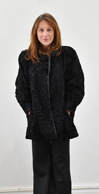 Lot 1344 - A black Persian lamb short jacket, lined in...