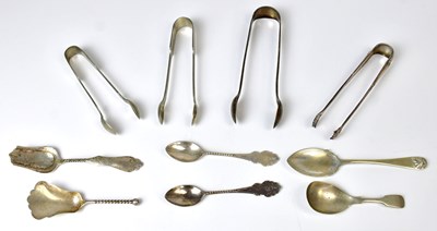 Lot 501 - A small collection of silver-plated sugar nips...