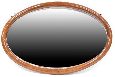 Lot 75 - A mahogany framed oval wall mirror with...