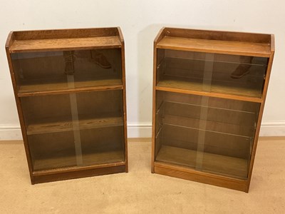 Lot 655 - A pair of oak glazed small bookcases, height...